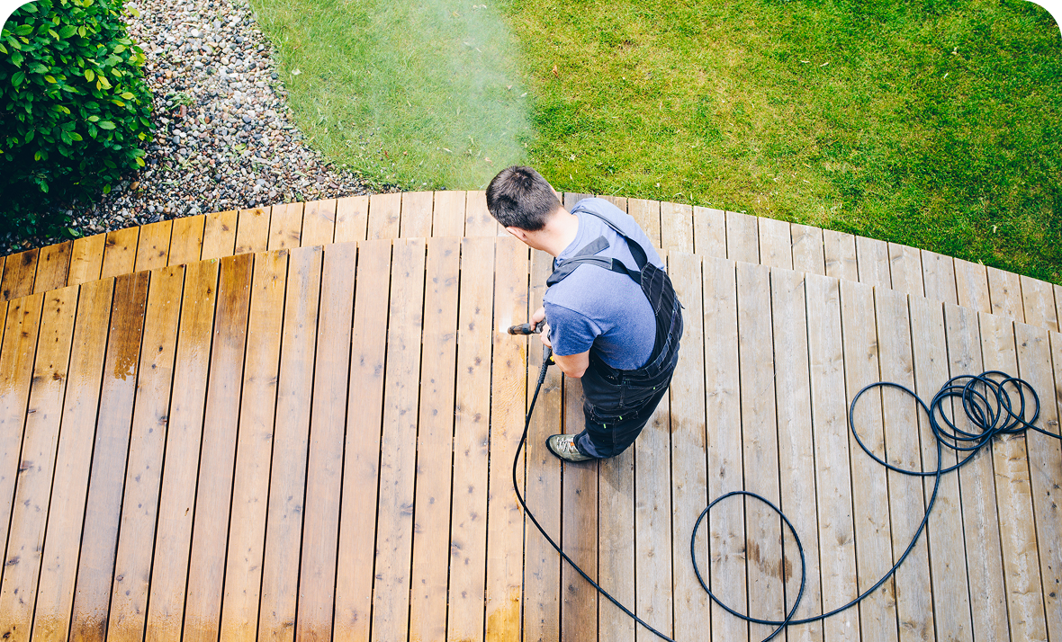 Cleaning wooden deck with pressure washer