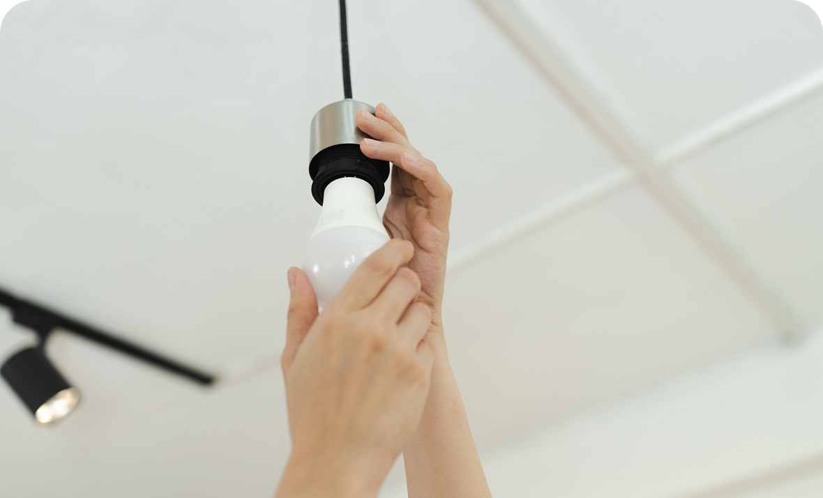 Technician adjusting lighting in kitchen